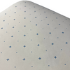 A roll of white paper with a pattern of blue crosses spaced evenly apart, likely used for garment design or pattern positioning.
