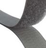 Close-up of mid grey hook and loop fastener tape showing both hook and loop sides on a white background